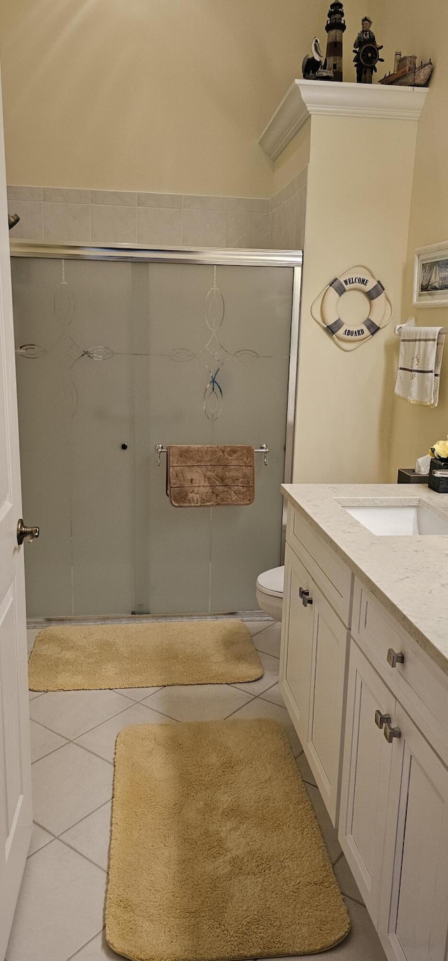 full bath featuring vanity, tile patterned flooring, a shower stall, and toilet