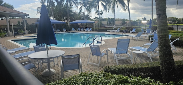 community pool featuring a patio and fence