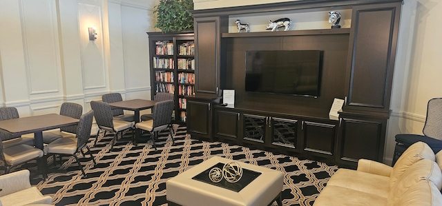 sitting room with dark colored carpet