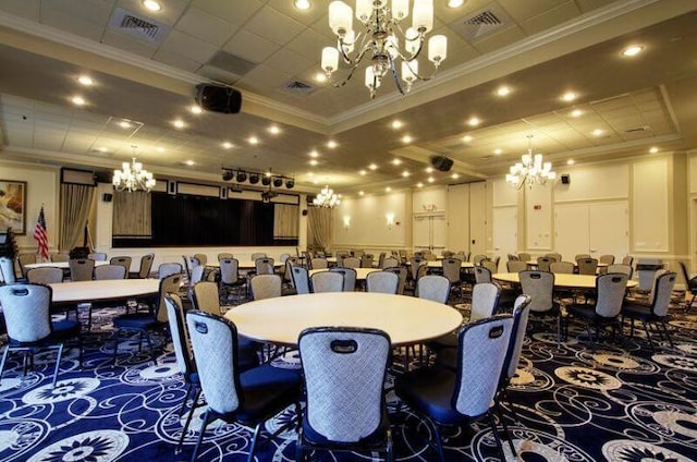 carpeted dining area with visible vents, a chandelier, and crown molding