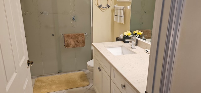 bathroom featuring tile patterned floors, a shower with shower door, vanity, and toilet