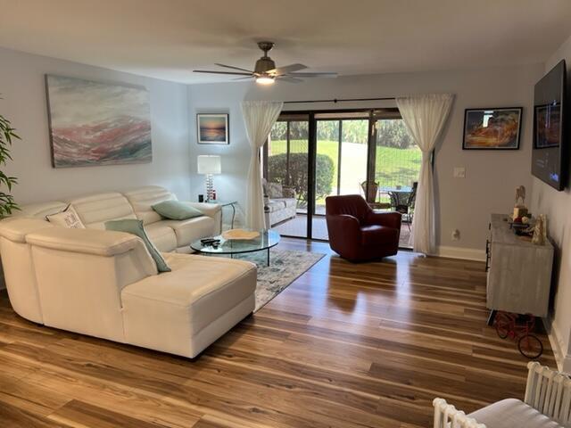 living room featuring hardwood / wood-style flooring and ceiling fan