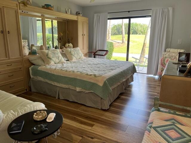 bedroom featuring access to exterior and hardwood / wood-style flooring