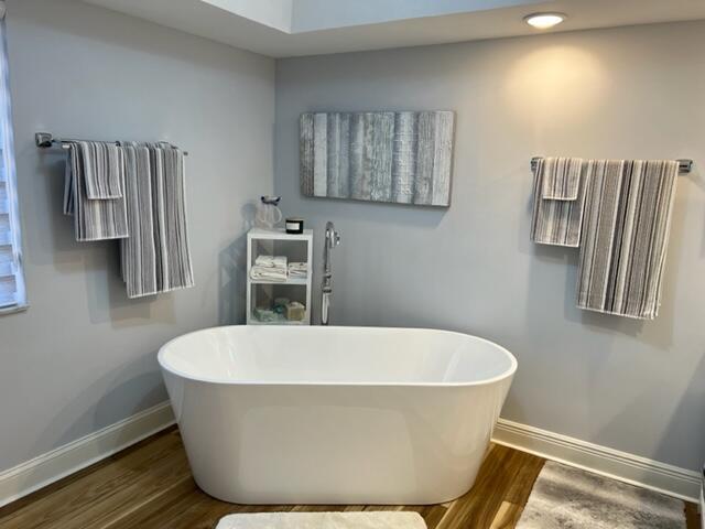 bathroom with vanity, hardwood / wood-style flooring, and a bathing tub