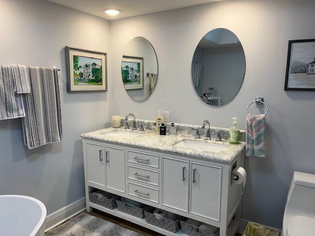 bathroom with hardwood / wood-style flooring and a bathtub