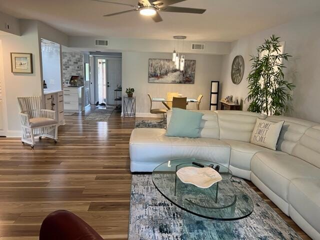 living room featuring ceiling fan and hardwood / wood-style floors