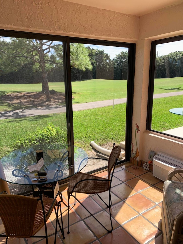 sunroom with a wall mounted air conditioner