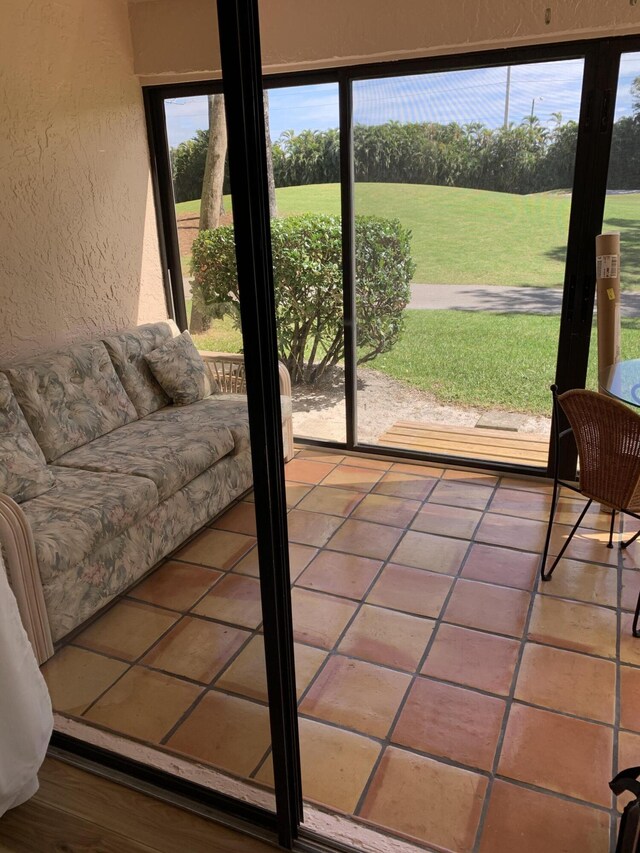 sunroom with a wall mounted air conditioner