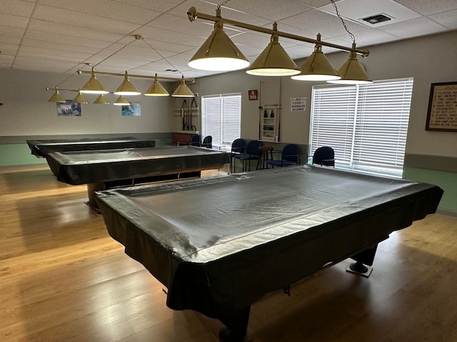 game room with pool table, a drop ceiling, and light hardwood / wood-style flooring