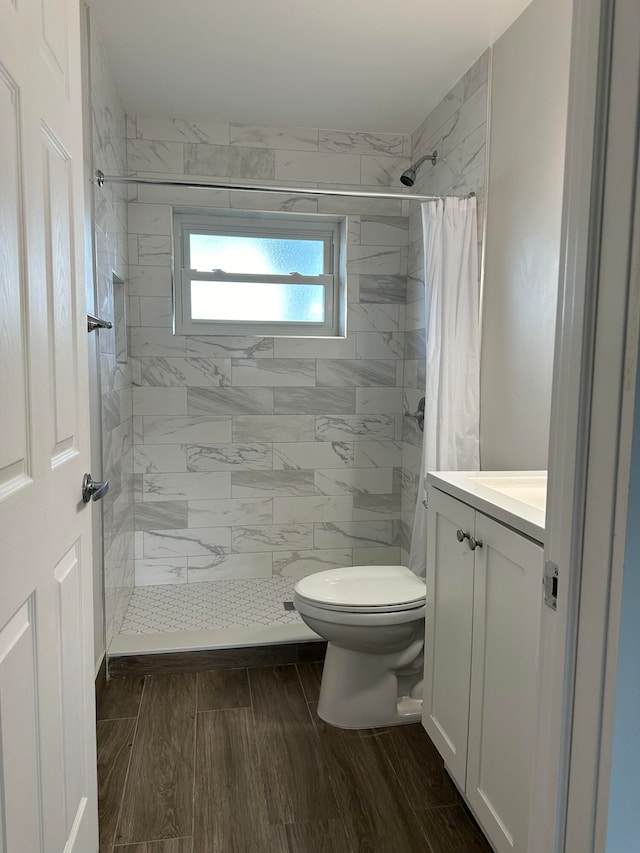 bathroom with vanity, toilet, and a shower with shower curtain