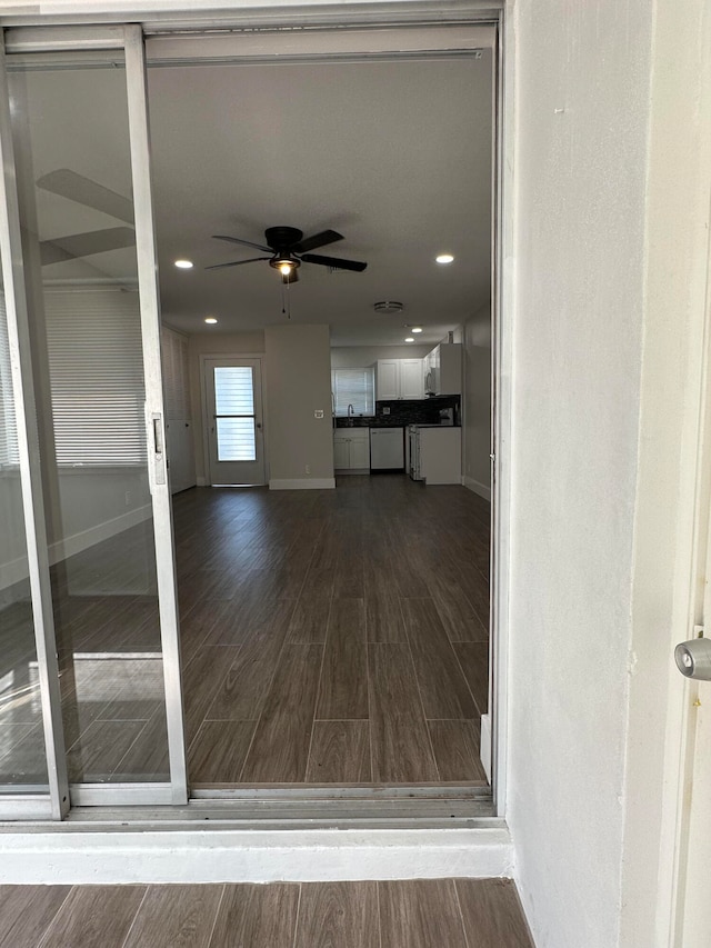 interior space with ceiling fan