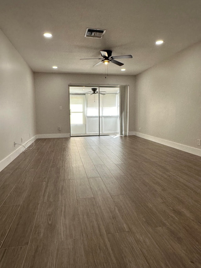 spare room with ceiling fan and dark hardwood / wood-style flooring