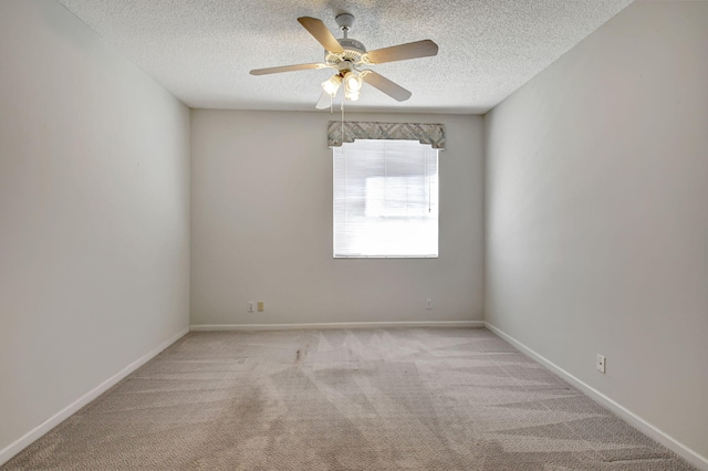 unfurnished room with light colored carpet, a textured ceiling, and ceiling fan