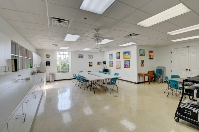 interior space with ceiling fan and a paneled ceiling