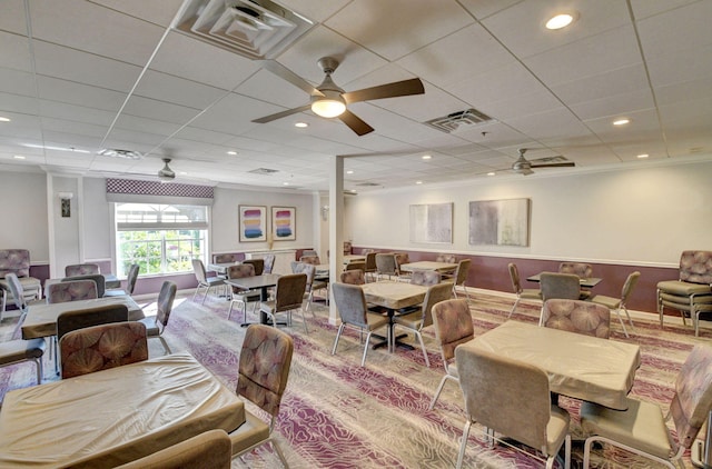 dining area with crown molding and ceiling fan