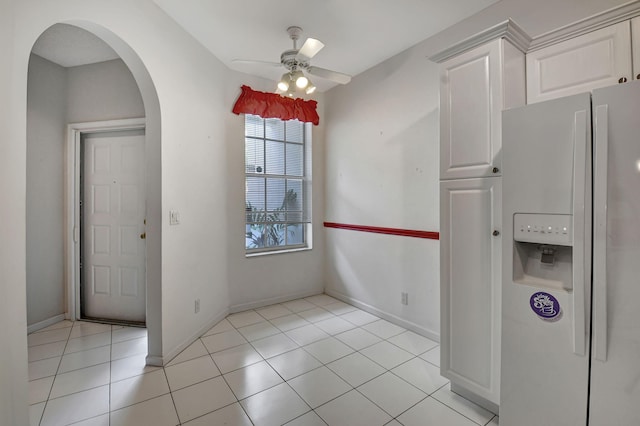 unfurnished dining area featuring ceiling fan and light tile patterned floors