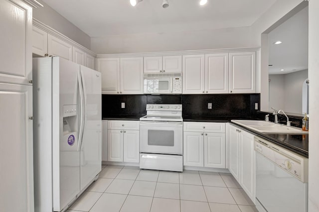 kitchen with sink, white appliances, backsplash, and white cabinets