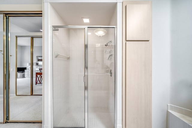 bathroom featuring a shower with door