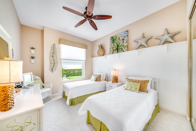 bedroom with ceiling fan and light colored carpet