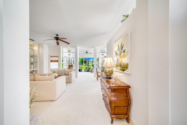 carpeted living room featuring ceiling fan