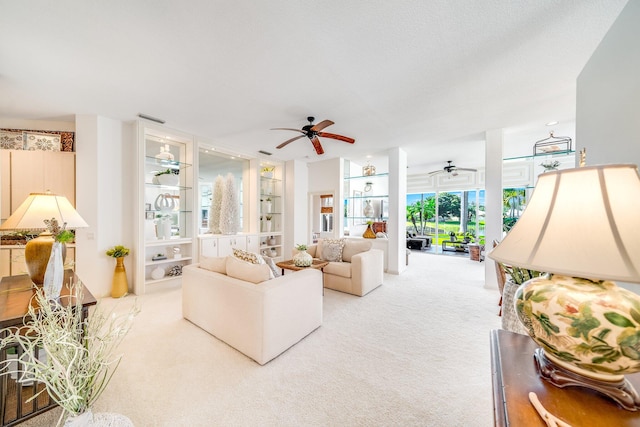 carpeted living room featuring ceiling fan and a textured ceiling