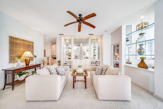 carpeted living room featuring ceiling fan