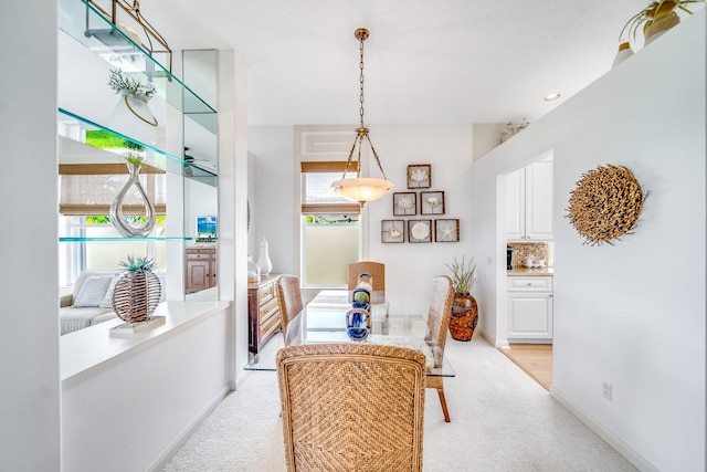 carpeted dining space featuring a wealth of natural light