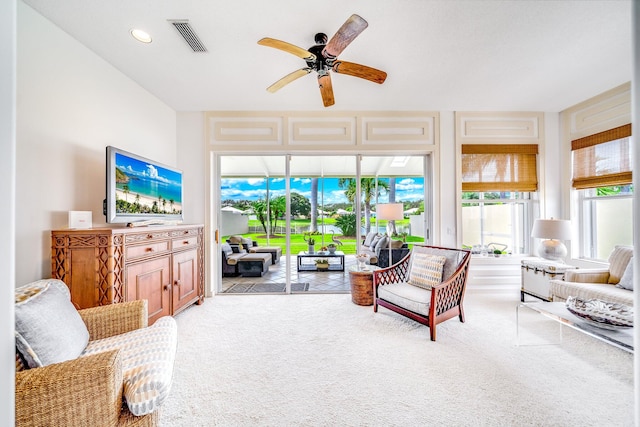 carpeted living room featuring ceiling fan