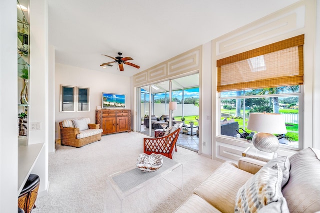 sunroom / solarium featuring a healthy amount of sunlight and ceiling fan