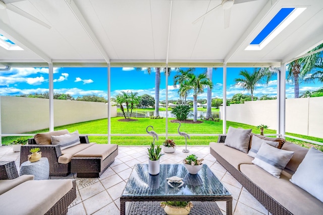 sunroom / solarium featuring ceiling fan and a skylight