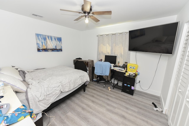 bedroom with ceiling fan and light wood-type flooring