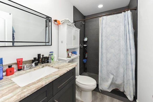 bathroom featuring vanity, hardwood / wood-style floors, toilet, and a shower with shower curtain