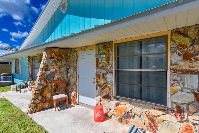 view of exterior entry featuring a patio