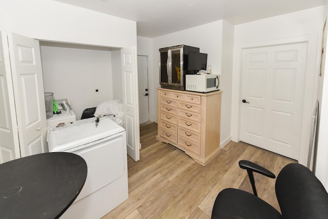 washroom featuring washer / clothes dryer and light hardwood / wood-style floors