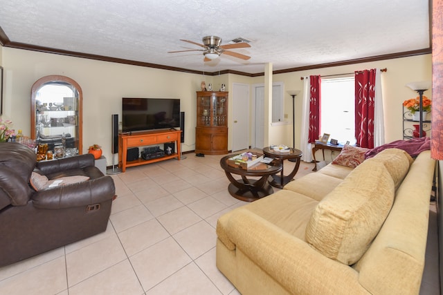 living room featuring light tile patterned floors, ornamental molding, ceiling fan, and plenty of natural light