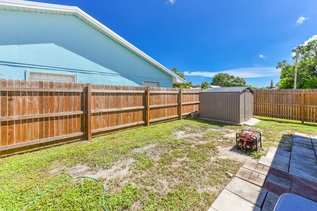 view of yard with a storage shed and a patio