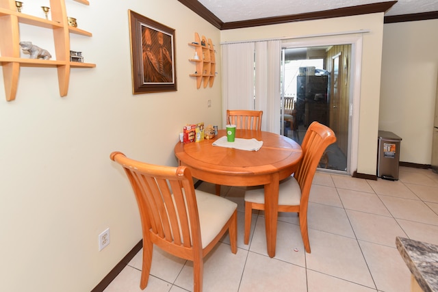 dining space with ornamental molding and light tile patterned flooring