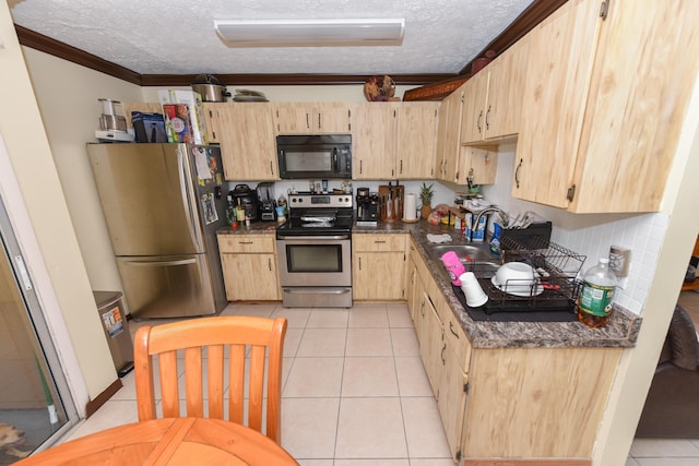 kitchen featuring light brown cabinetry, appliances with stainless steel finishes, crown molding, and light tile patterned floors