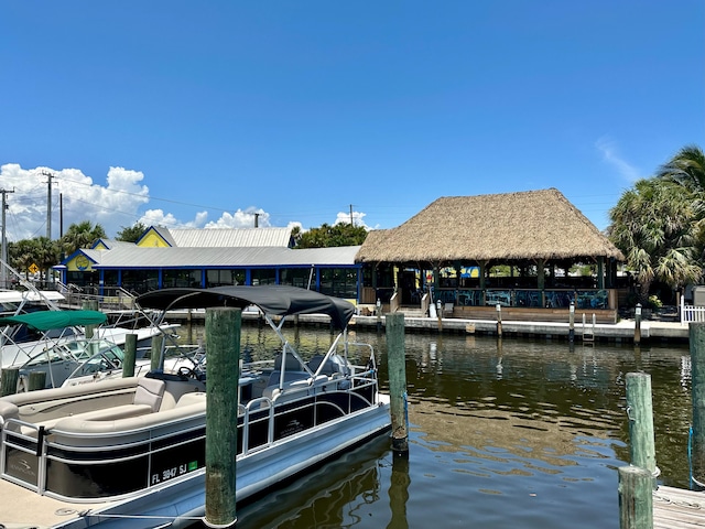 view of dock with a gazebo and a water view