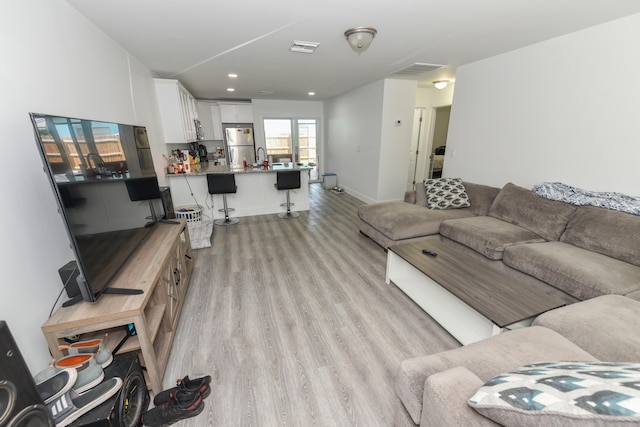 living room with light hardwood / wood-style flooring