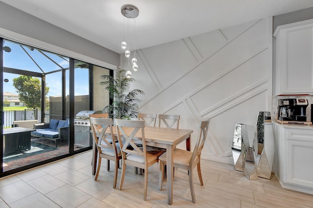 dining area with lofted ceiling with beams and light wood-type flooring