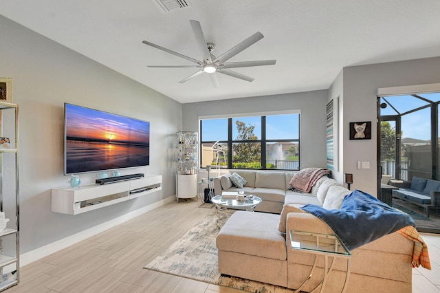 living room featuring light wood-type flooring, ceiling fan, and a healthy amount of sunlight