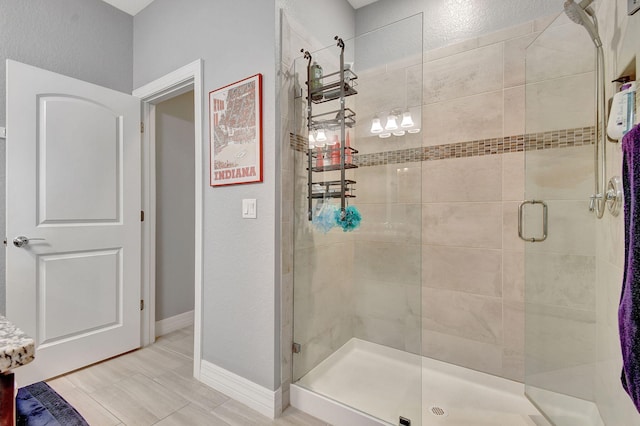 bathroom featuring a shower with shower door