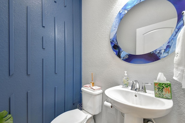 bathroom featuring sink and toilet