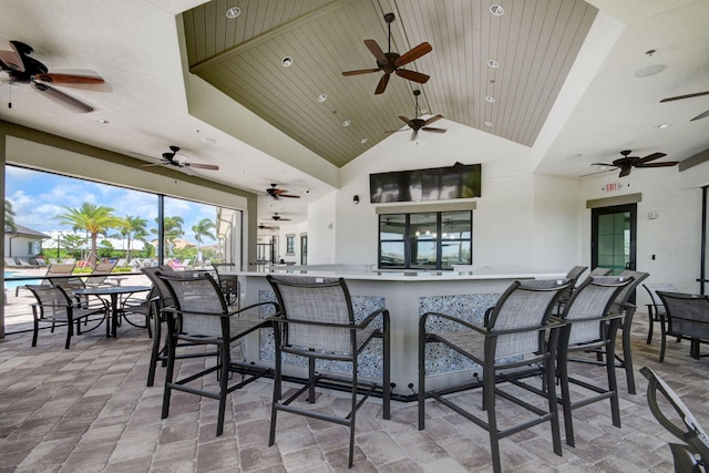 exterior space with ceiling fan and a bar