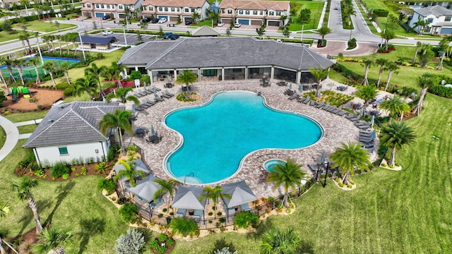 view of swimming pool featuring a lawn and a patio area