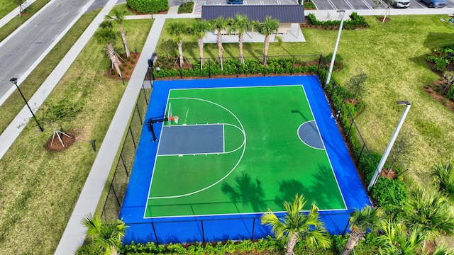 view of basketball court with a yard