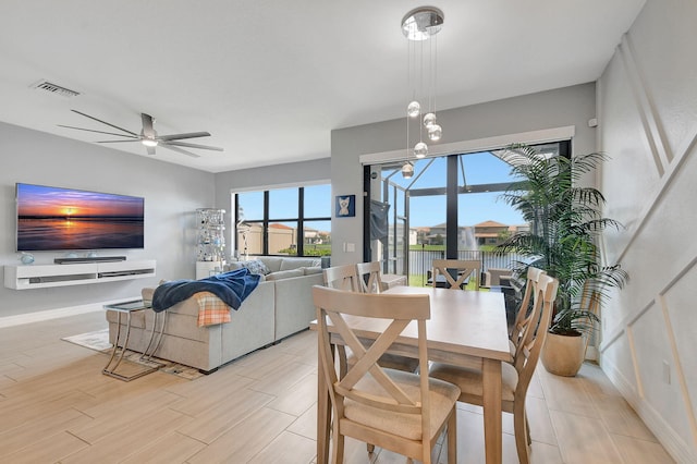 dining room with ceiling fan and light hardwood / wood-style flooring