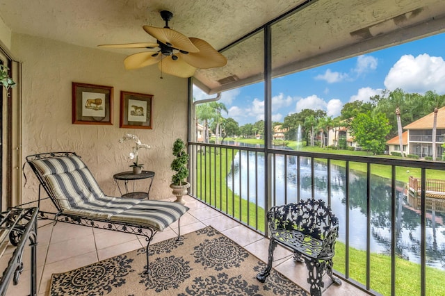 balcony featuring a water view and ceiling fan