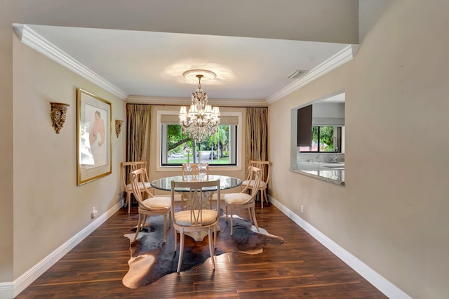 dining space featuring a chandelier, dark wood-type flooring, and crown molding